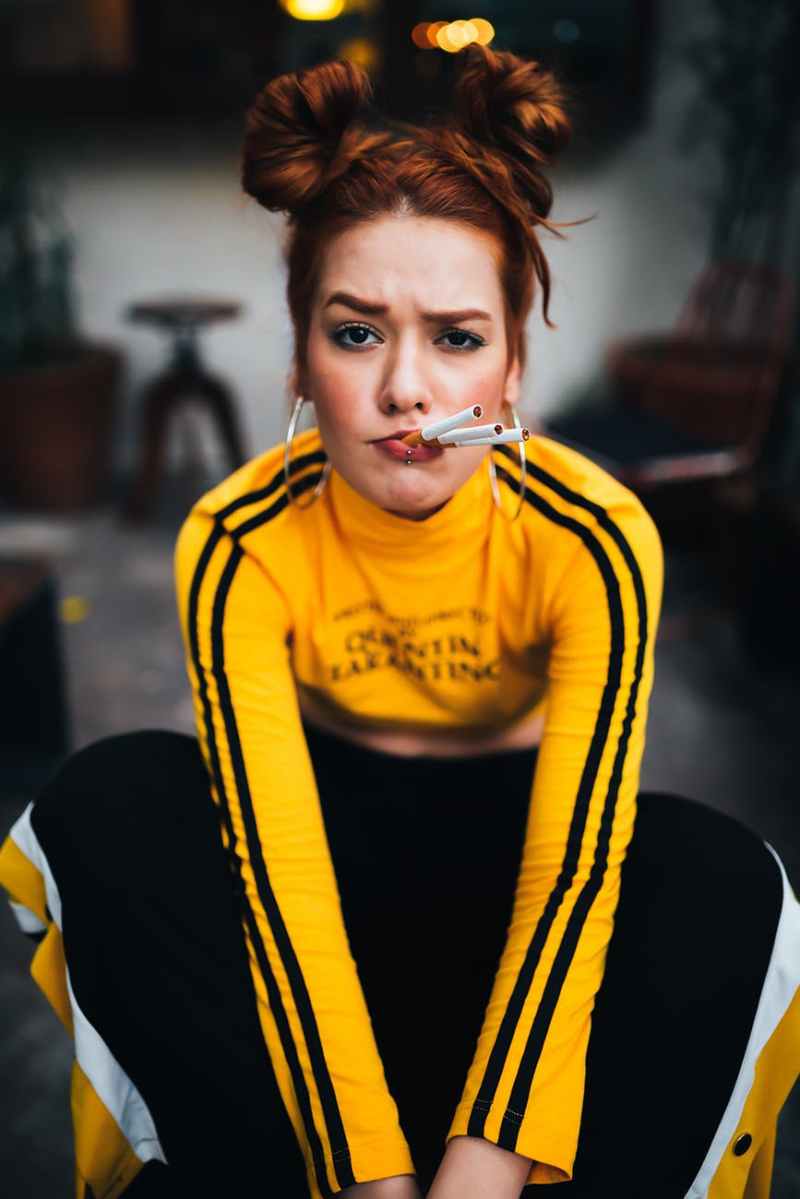 woman in yellow and black long sleeved shirt and black pants