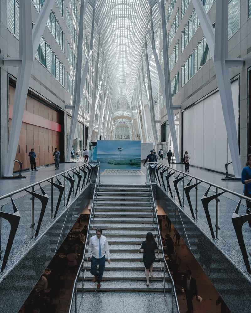 people walking inside glass building