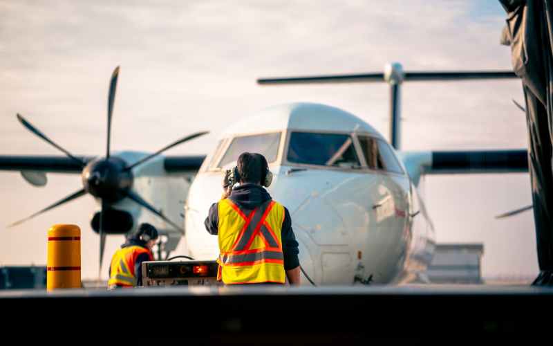 man standing in front of airplane